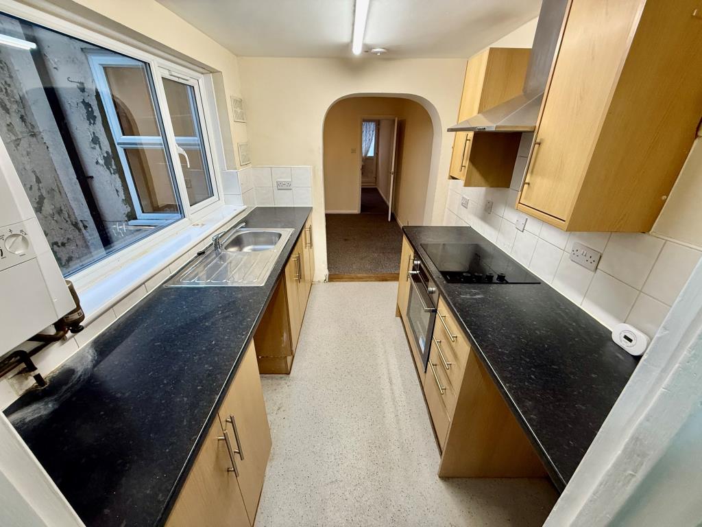 Lot: 101 - THREE STOREY HOUSE FOR IMPROVEMENT - Kitchen leading to dining room